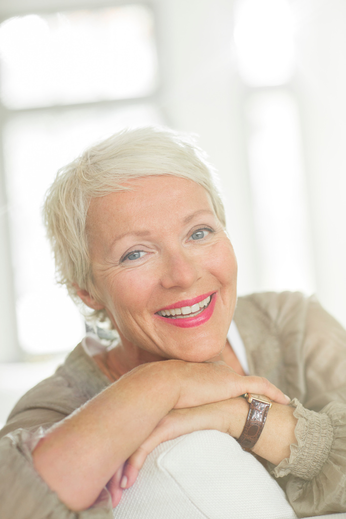 Older woman smiling on sofa